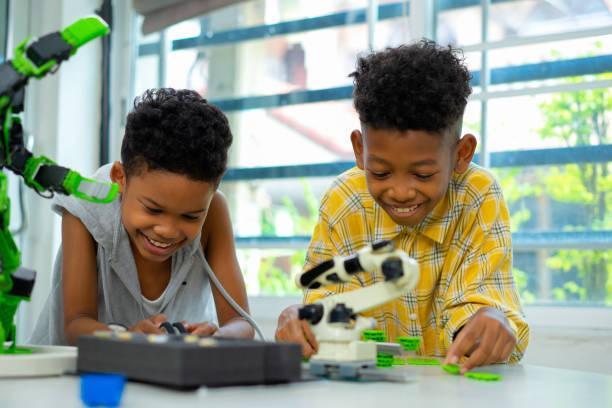 African american boys are setting robot kit in science classroom